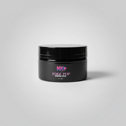 Black jar of hair product with a pink background